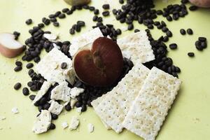 Half of Plumcot fruit and biscuit put on pastel background, photo