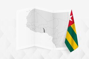A grayscale map of Togo with a hanging Togolese flag on one side. Map for many types of news. vector