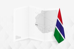 A grayscale map of Gambia with a hanging Gambian flag on one side. Map for many types of news. vector