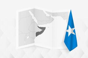 A grayscale map of Somalia with a hanging Somali flag on one side. Map for many types of news. vector