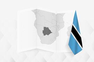 A grayscale map of Botswana with a hanging Botswanan flag on one side. Map for many types of news. vector