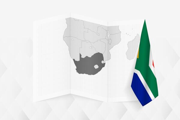 A grayscale map of South Africa with a hanging South African flag on one side. Map for many types of news.