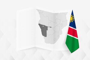 A grayscale map of Namibia with a hanging Namibian flag on one side. Map for many types of news. vector