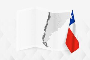 A grayscale map of Chile with a hanging Chilean flag on one side. Map for many types of news. vector