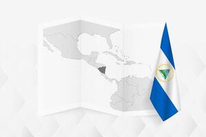 A grayscale map of Nicaragua with a hanging Nicaraguan flag on one side. Map for many types of news. vector