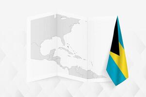 A grayscale map of The Bahamas with a hanging Bahamian flag on one side. Map for many types of news. vector