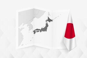 A grayscale map of Japan with a hanging Japanese flag on one side. Map for many types of news. vector