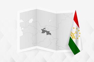 A grayscale map of Tajikistan with a hanging Tajikistani flag on one side. Map for many types of news. vector