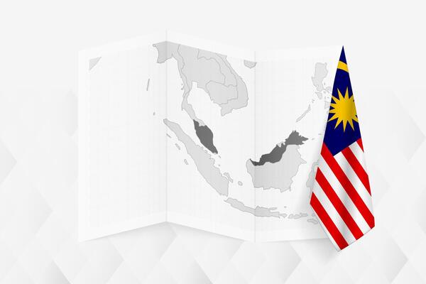 A grayscale map of Malaysia with a hanging Malaysian flag on one side. Map for many types of news.