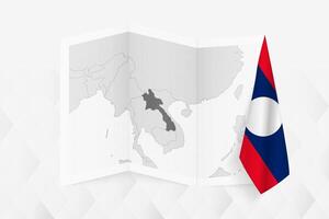 A grayscale map of Laos with a hanging Laotian flag on one side. Map for many types of news. vector