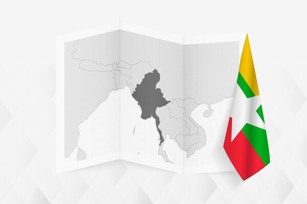 A grayscale map of Myanmar with a hanging Myanmar flag on one side. Map for many types of news.