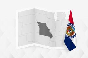 A grayscale map of Missouri with a hanging Missouri flag on one side. Map for many types of news. vector