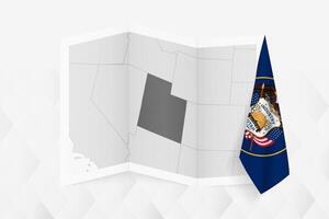 A grayscale map of Utah with a hanging Utah flag on one side. Map for many types of news. vector