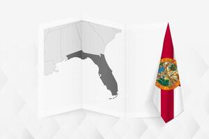A grayscale map of Florida with a hanging Florida flag on one side. Map for many types of news. vector
