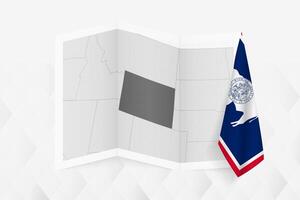 A grayscale map of Wyoming with a hanging Wyoming flag on one side. Map for many types of news. vector