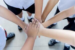 Diverse people join hands in team building. Activity men and women put hands together. photo