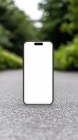 Black smartphone mockup template with blank screen on the road photo