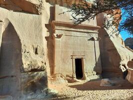 A beautiful view of the caves built into the mountains at the archaeological site of Hegra in Madain Saleh, AlUla in Saudi Arabia. photo