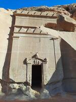 A beautiful view of the caves built into the mountains at the archaeological site of Hegra in Madain Saleh, AlUla in Saudi Arabia. photo
