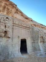 A beautiful view of the caves built into the mountains at the archaeological site of Hegra in Madain Saleh, AlUla in Saudi Arabia. photo