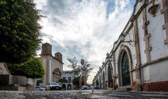 Exploring the cobblestone streets of Taxco de Alarcon in Guerrero during a cloudy afternoon photo