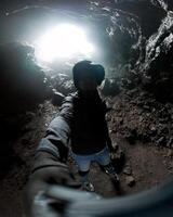Exploring a volcanic cave with ambient light during a thrilling adventure photo