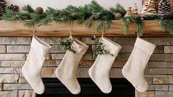 Eco-friendly Christmas scene with stockings made from recycled fabric, simple greenery, and wooden ornaments, enhancing the minimalist holiday decor. Christmas stockings, New Year video