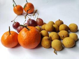 A group of oranges and grapes on a table photo