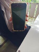 Person holding smartphone with transparent case photo