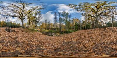 seamless spherical 360 hdri panorama in middle of oak forest near an abandoned pond or lake in golden autumn in equirectangular projection, ready VR AR virtual reality content photo