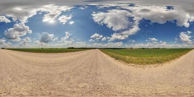 blue sky hdri 360 panorama with awesome clouds on gravel road among fields in spring day in equirectangular full seamless spherical projection, for VR AR content or skydome replacement photo