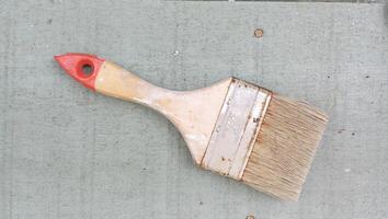 Rustic Paintbrush on Weathered Wooden Surface photo