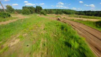 Dynamic FPV shot of a racer on a motocross bike on a track at high speed video
