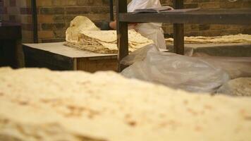 Close up fresh Lavash traditional Armenian flatbread on table in preparation. Scrumptious bread. Traditional flat bread preparation in Armenia video