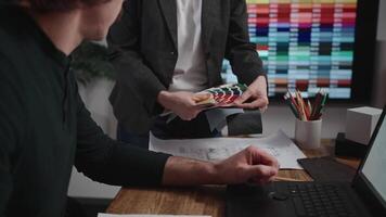 Unrecognizable interior designers select materials and color schemes for a modern apartment project. Teamwork in an architectural studio. video