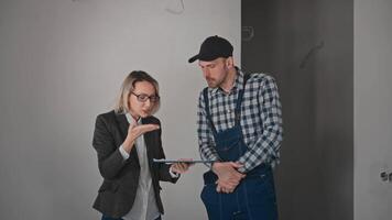 Conflict at a construction site. A woman is a customer, arguing with a builder contractor. The client is not satisfied with the construction work video