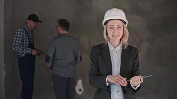 A woman in a hard hat is smiling in a room with two men at a formal event video
