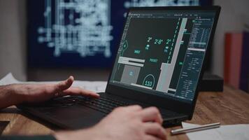 An unrecognizable architect works on a laptop with blueprints in a specialized program. The man is developing a construction project. The architect is designing a floor plan. video