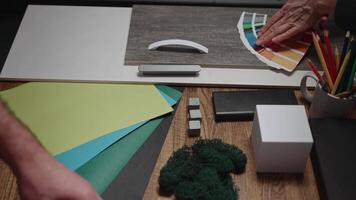 Unrecognizable interior designers select materials and color schemes for a modern apartment project. Teamwork in an architectural studio. video