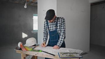 Man examining blueprint at table in hardwood building video