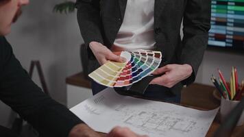 Unrecognizable interior designers select materials and color schemes for a modern apartment project. Teamwork in an architectural studio. video