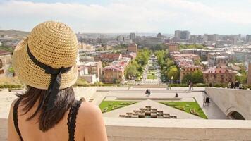 Happy tourist girl enjoy cascade complex viewpoint with raised her hands and rejoices wonderful view of the main tourist attraction of Yerevan capital Armenia video