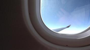 Looking out the airplane window, seeing the clouds and coastline below video