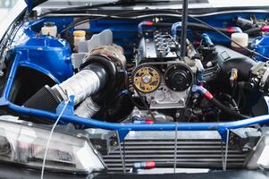 Close-up of modified high-performance car engine intricate components, vibrant colors, and advanced technology Perfect for automotive enthusiasts and engineering photo