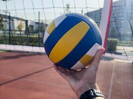 Volleyball action. Ball above net during volleyball game. photo