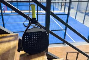 padel racket on a padel court with a ball photo