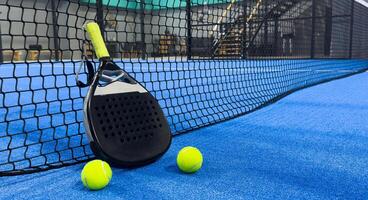 padel racket on a padel court with a ball photo