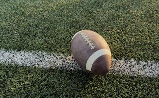 Football at the goal line on a grass field overhead view photo