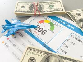 Credit Report text on paper sheet with toy fighter, war photo