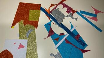 Details of cut foamiran of different colors in sparkles on table photo